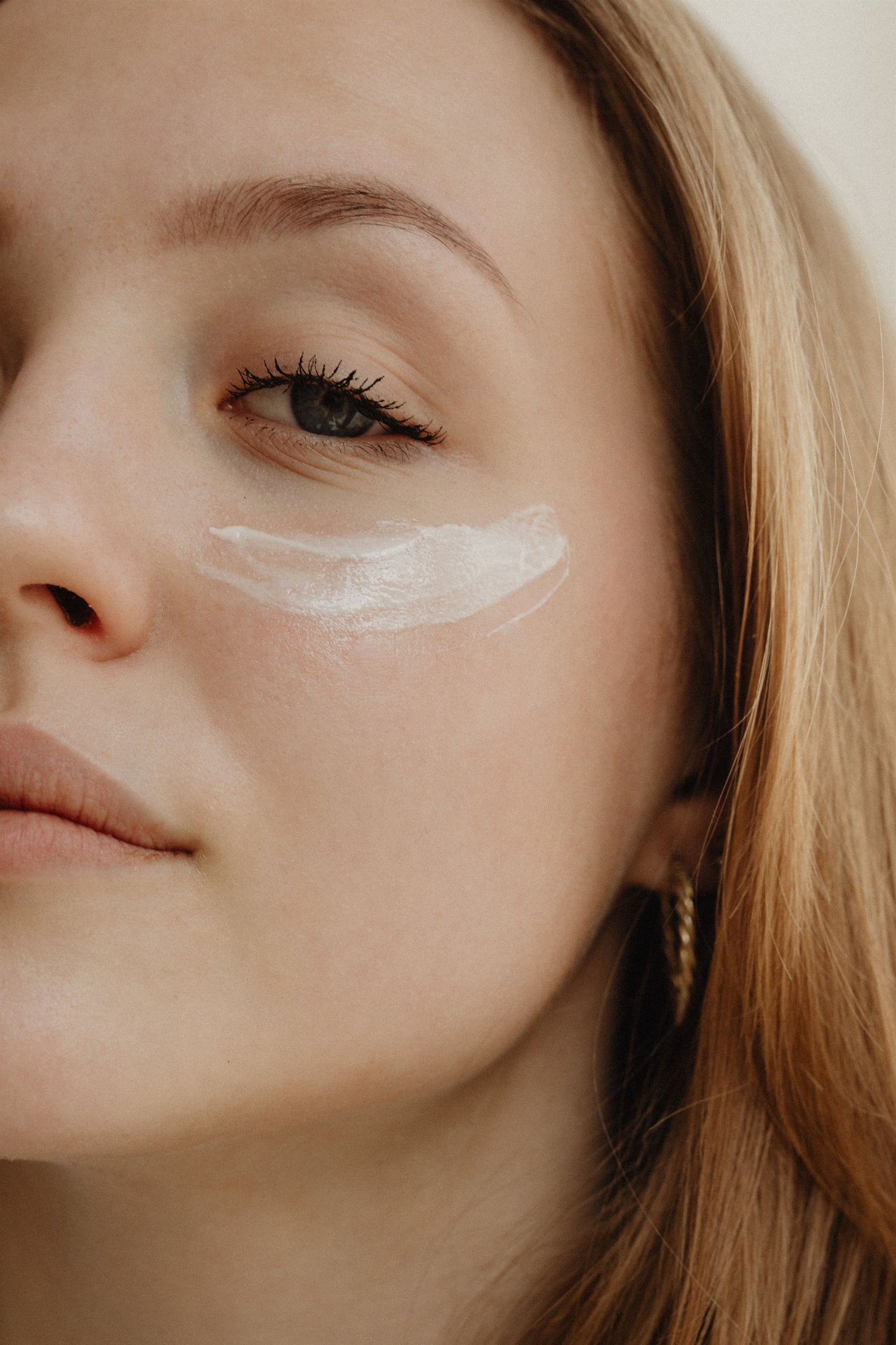 house of tallow hydrating face cream woman applying product to her face